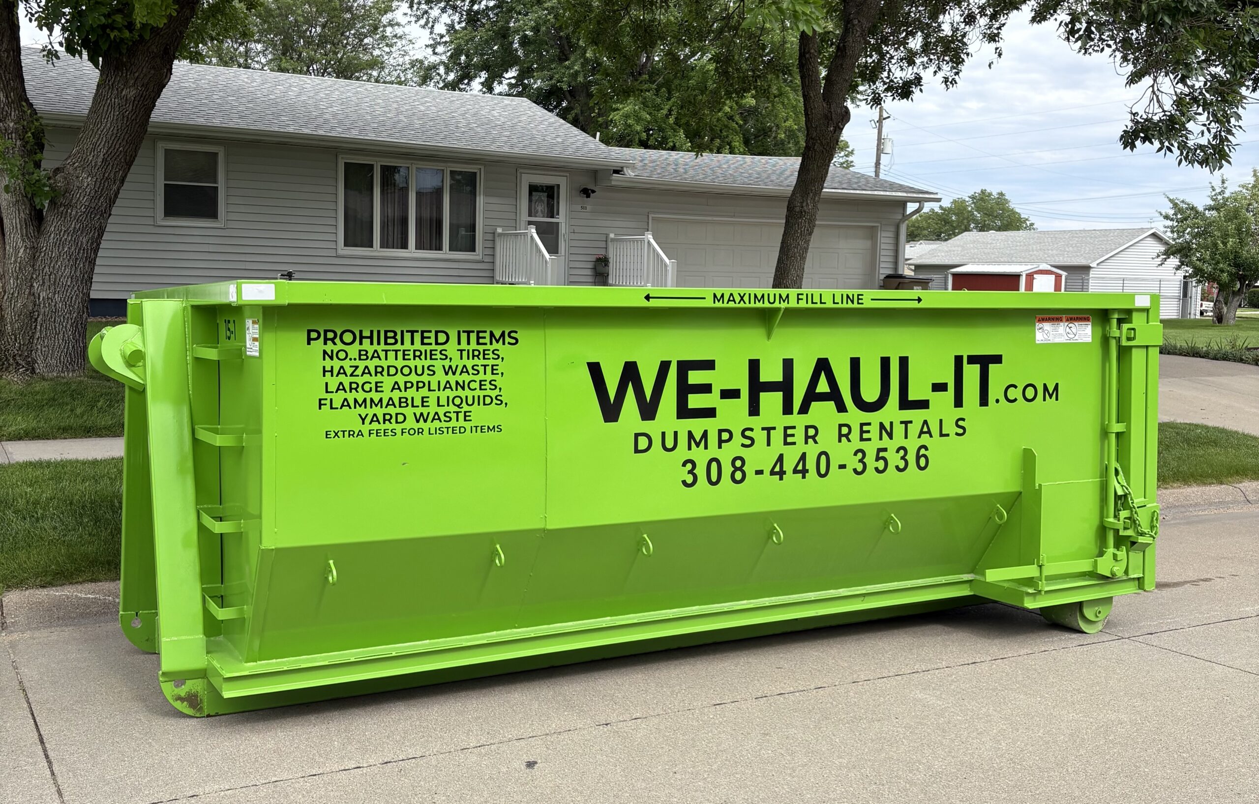 WE-HAUL-IT 15 yard roll-off dumpster being placed on a Central Nebraska driveway