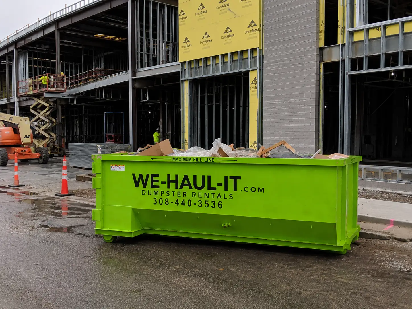 WE-HAUL-IT roll-off dumpster on a Buffalo County construction job site